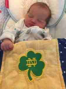baby with notre dame quilt
