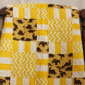 yellow and brown dinosaur patchwork quilt